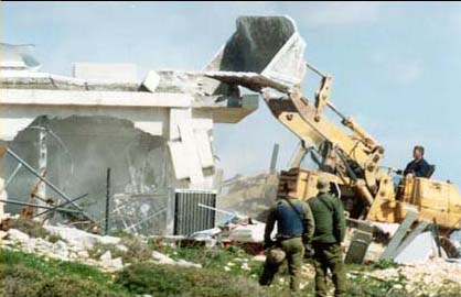 Caterpillar bulldozer destroying palestinian home